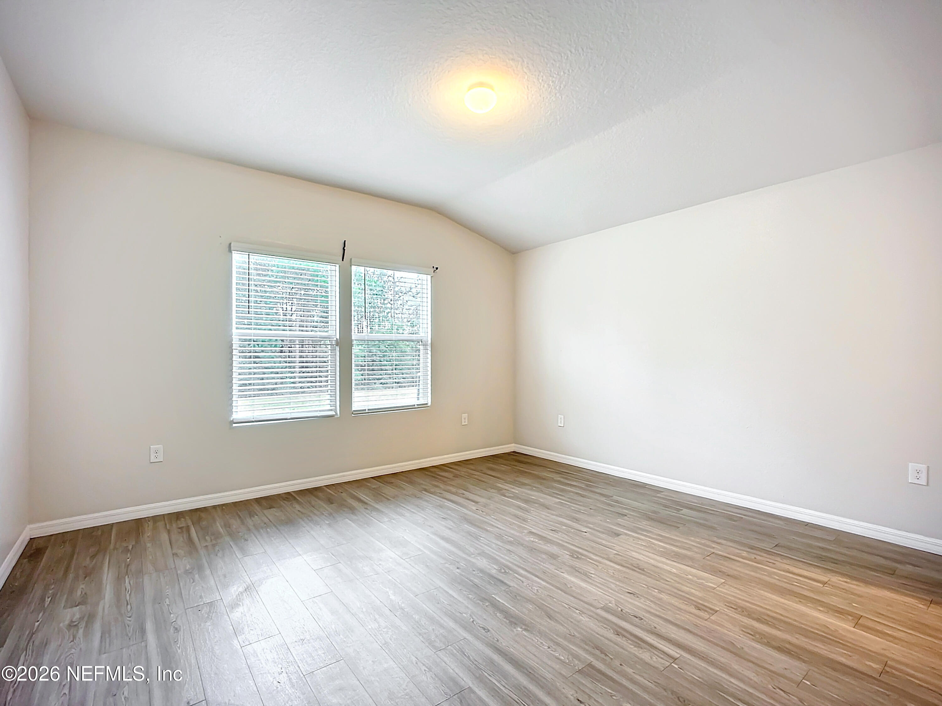 1360 Tan Tara Trail Jacksonville, FL 32221 - Photo 6 of 23 an empty room with wooden floor and windows