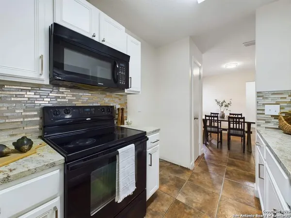 a kitchen with a stove and a microwave