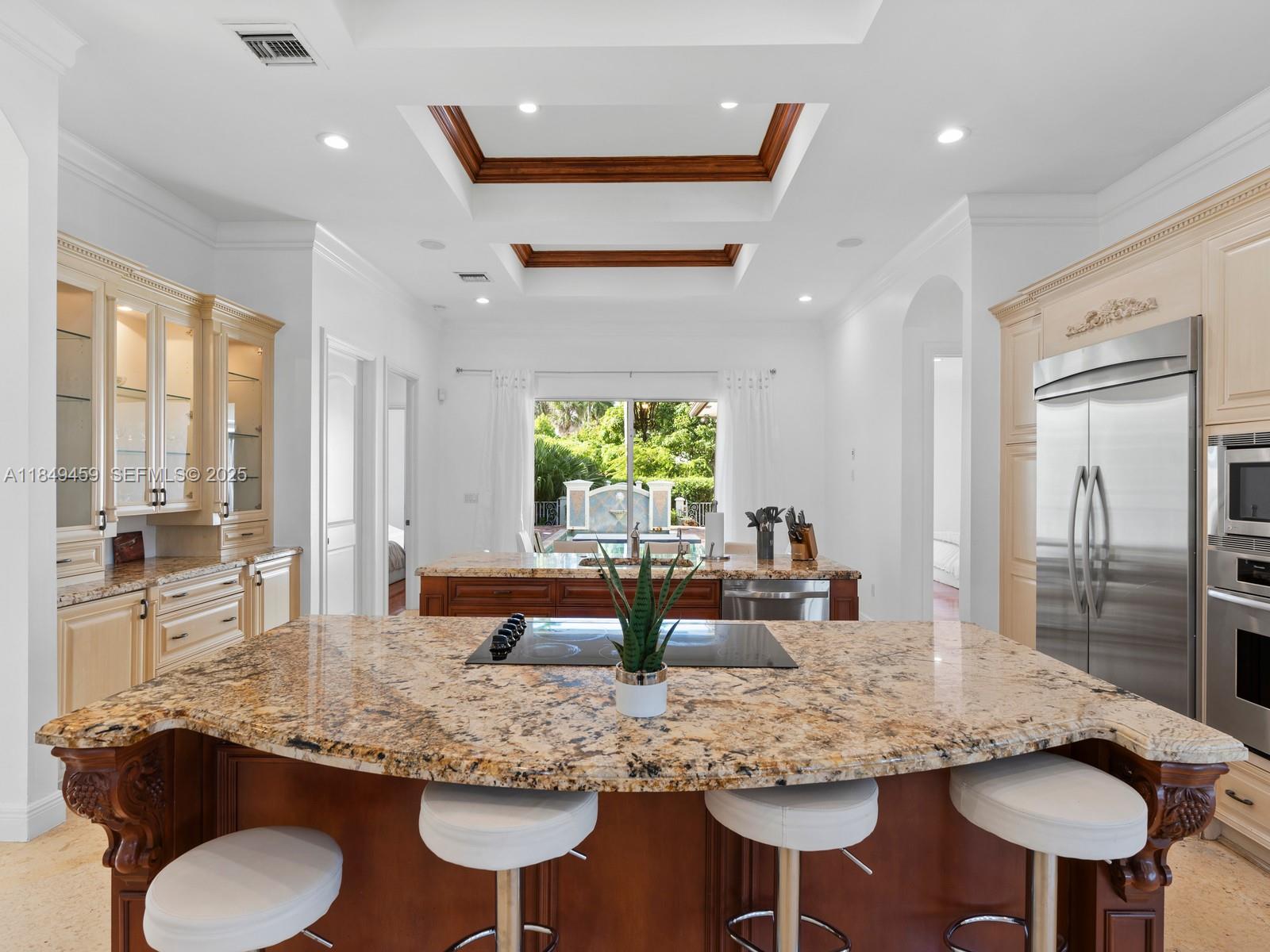 1223 Jackson Street Hollywood, FL 33019 - Photo 17 of 41 a kitchen with stainless steel appliances granite countertop a kitchen island and a refrigerator in it