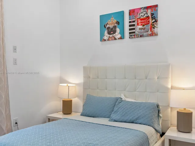 a bedroom with a bed and wall painting