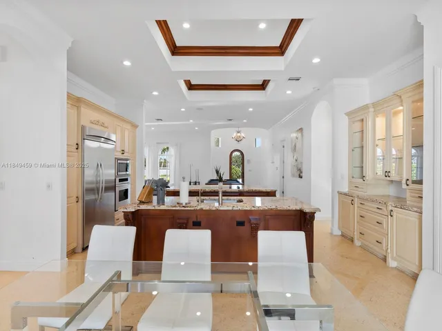 a large kitchen with a table and chairs