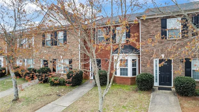 a view of a brick building next to a yard