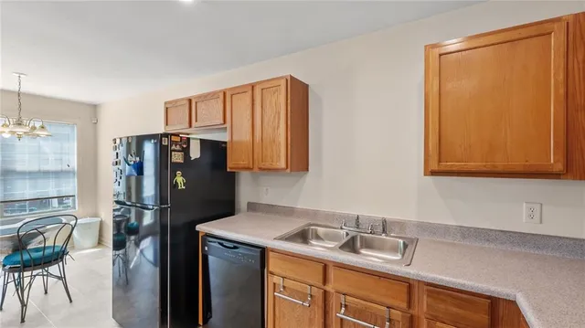 a kitchen with a refrigerator and a sink