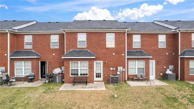 a front view of a house with swimming pool and porch