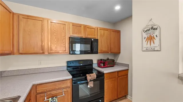 a kitchen with stainless steel appliances granite countertop a stove and a microwave