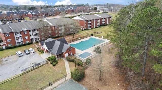 an aerial view of multiple houses with yard