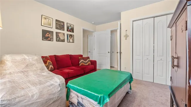 a living room with a bed and a window