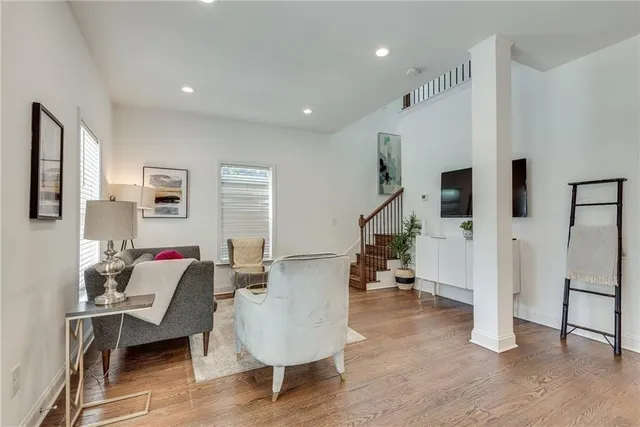a living room with furniture and a wooden floor