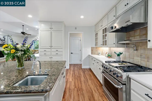 a living room with furniture a fireplace and a ceiling fan