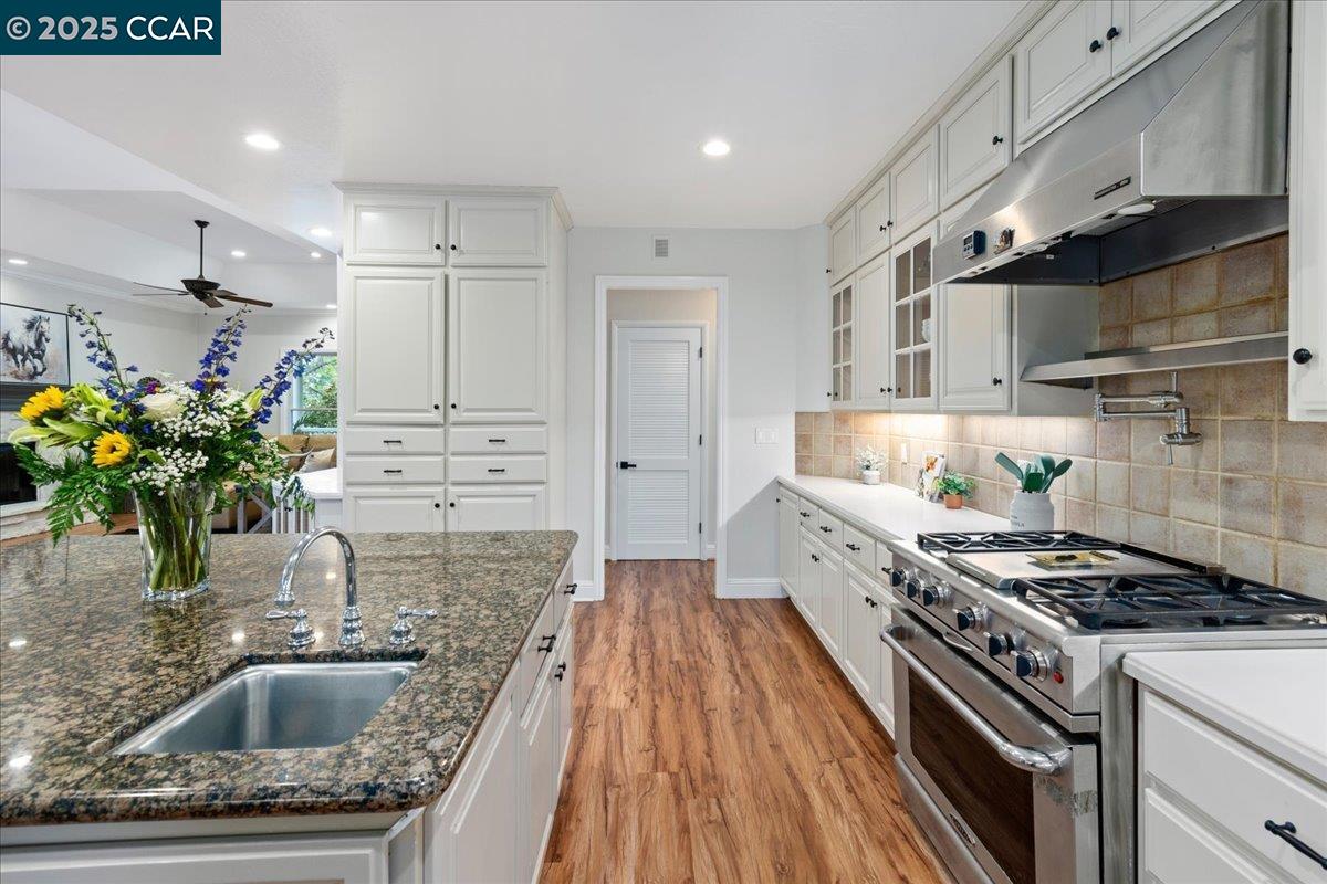 1101 North Gate Road Walnut Creek, CA 94598 - Photo 12 of 56 a kitchen with stainless steel appliances kitchen island granite countertop a sink stove and refrigerator