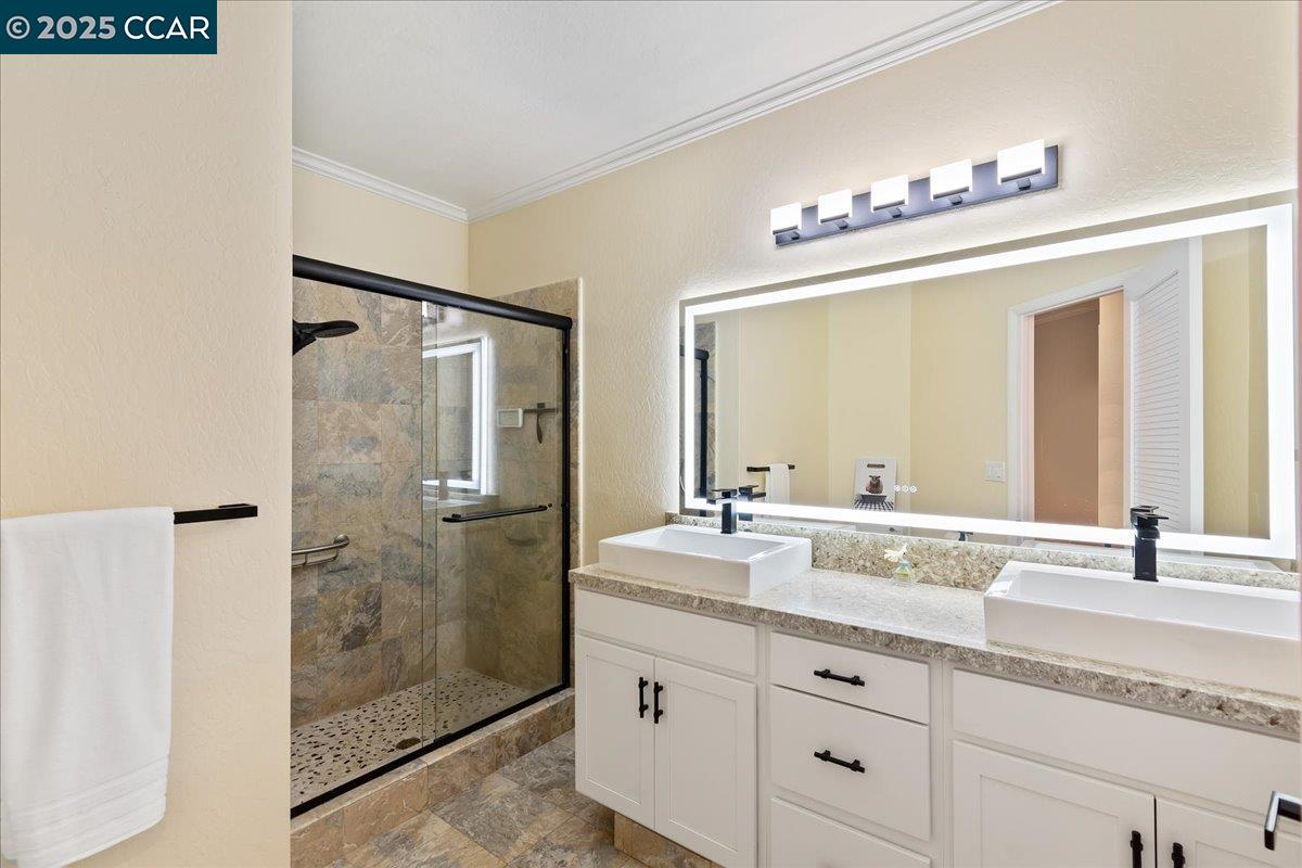 1101 North Gate Road Walnut Creek, CA 94598 - Photo 22 of 56 a bathroom with a granite countertop sink mirror and shower