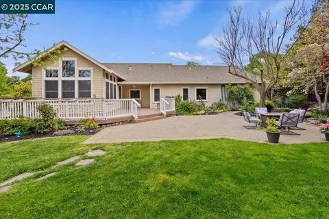 a view of a chairs and table in the backyard