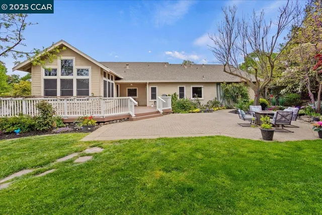 a view of a chairs and table in the backyard