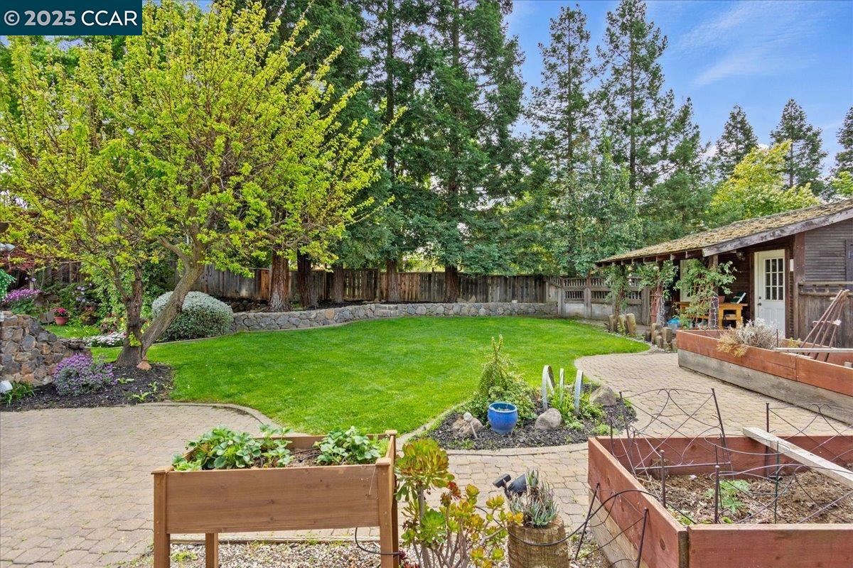 1101 North Gate Road Walnut Creek, CA 94598 - Photo 26 of 56 a view of a garden with plants and a bench