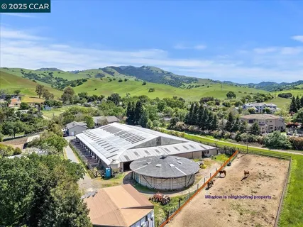 an aerial view of a house with a yard and lake view
