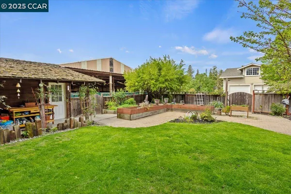 a view of a backyard with table and chairs and potted plants