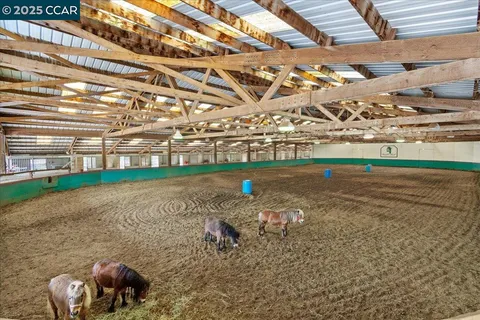 a backyard of a house with lots of green space and outdoor seating