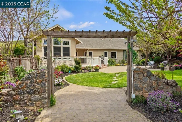 a kitchen with stainless steel appliances granite countertop a kitchen island hardwood floor sink and stove