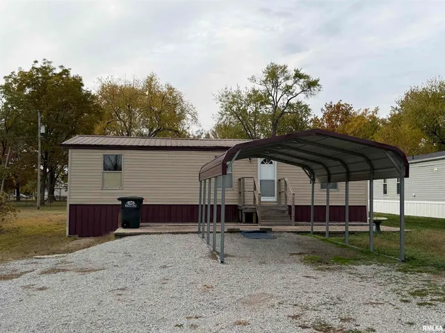 a view of house with backyard space and trampoline