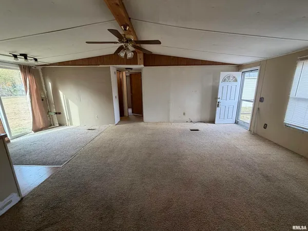 a view of a livingroom with a ceiling fan and window