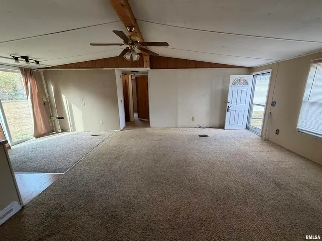 a view of a livingroom with a ceiling fan and window