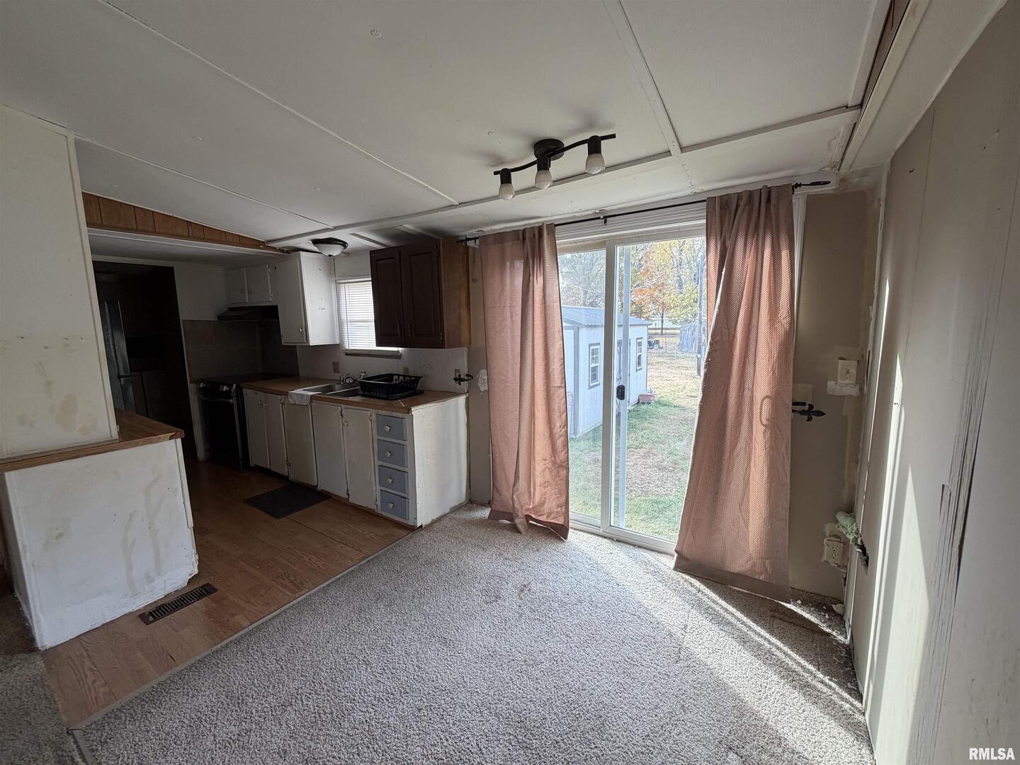 507 Wortby Street Odin, IL 62870 - Photo 7 of 15 a kitchen with stainless steel appliances granite countertop a refrigerator a sink a stove and white cabinets