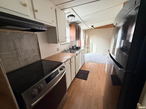 a kitchen with granite countertop a stove and a refrigerator
