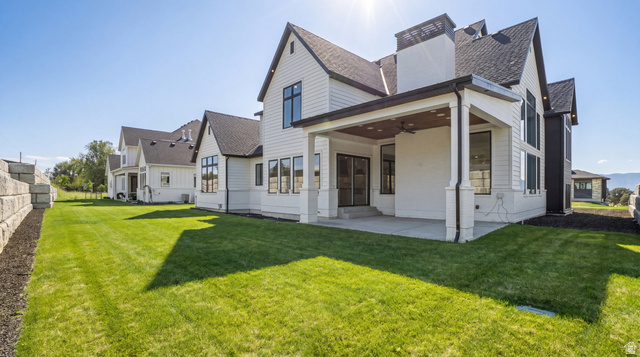 1682 North 1950 W Street, Unit 9 Provo, UT 84604 - Photo 66 of 84 Expansive rear facade featuring white siding, black-framed windows, and a covered patio with a ceiling fan