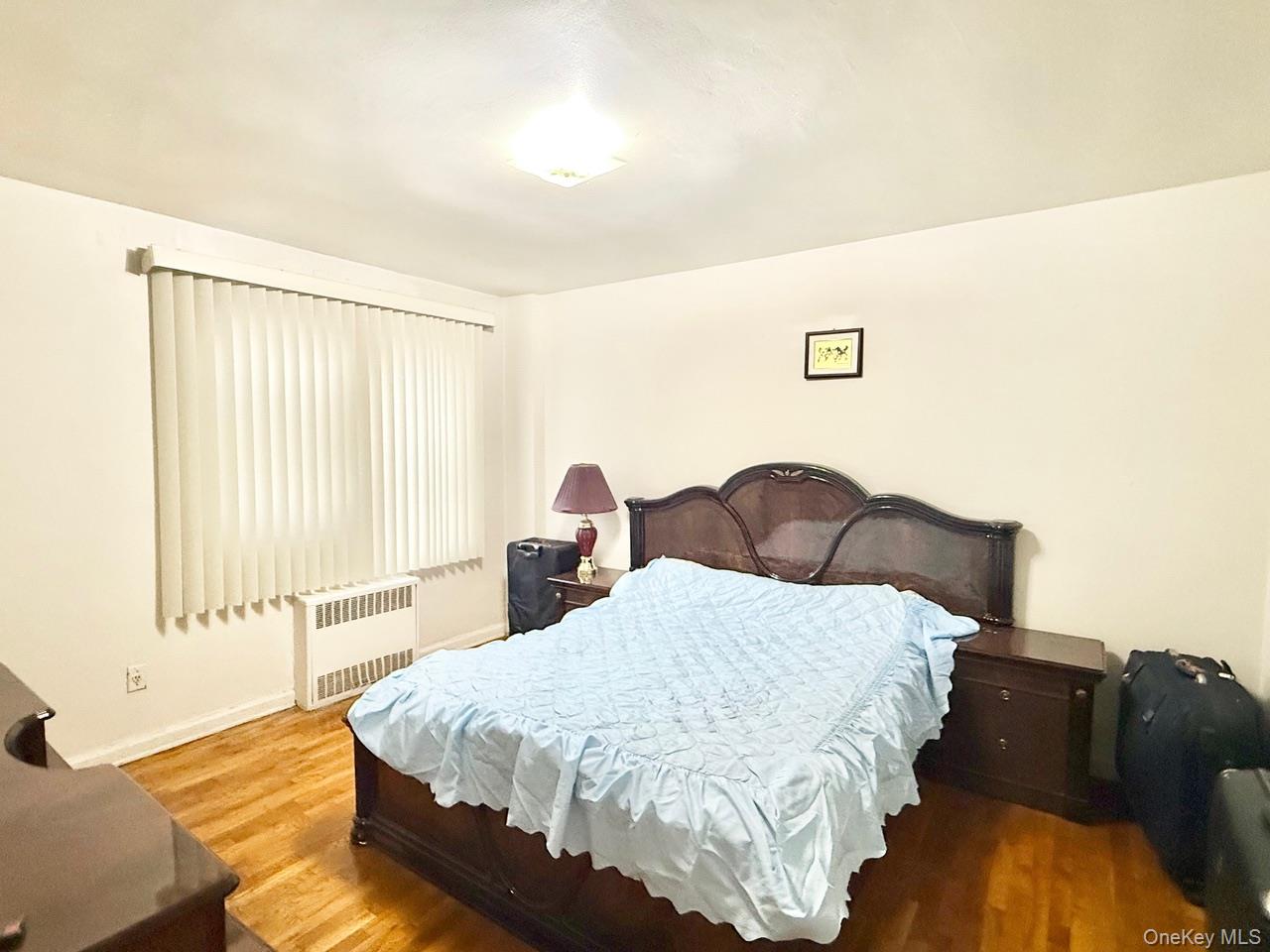 43-35 Union Street, Unit 2G Queens, NY 11355 - Photo 11 of 15 a spacious bedroom with a bed and wooden floor