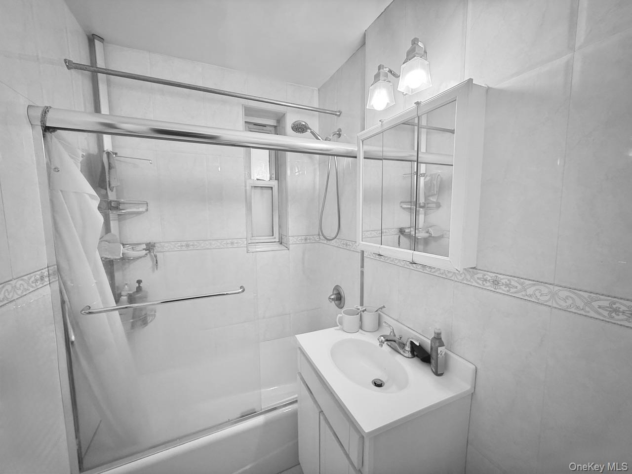 43-35 Union Street, Unit 2G Queens, NY 11355 - Photo 13 of 15 a bathroom with a sink mirror and shower