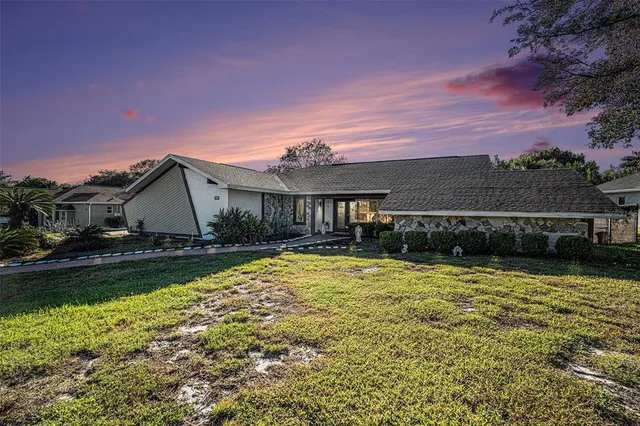 a view of a house with swimming pool and a yard