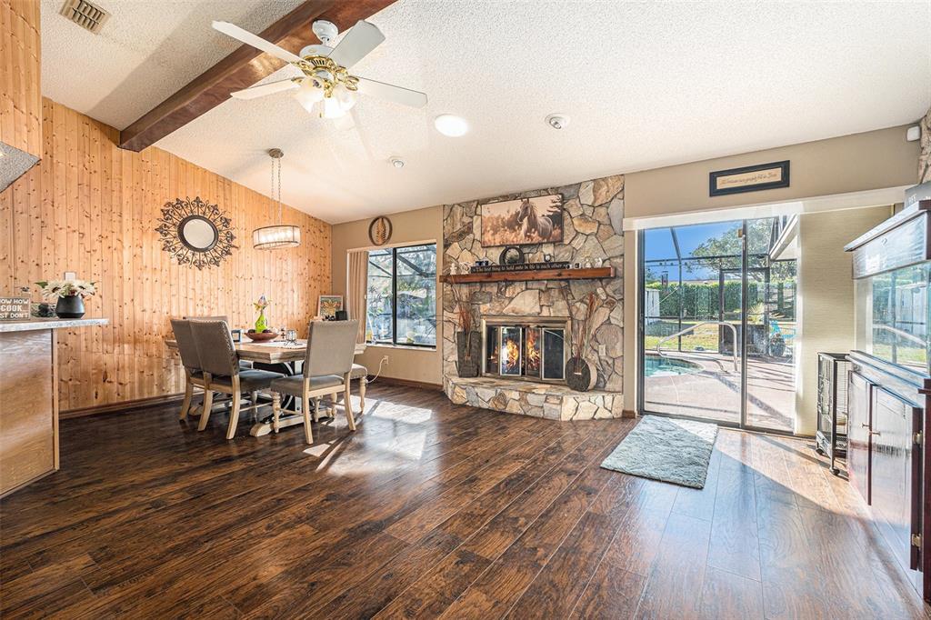 8212 Delaware Drive Weeki Wachee, FL 34607 - Photo 13 of 33 a living room with furniture and a fireplace
