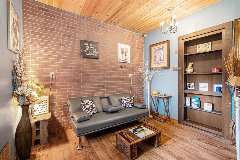 8212 Delaware Drive Weeki Wachee, FL 34607 - Photo 14 of 33 a living room with furniture and a book shelf