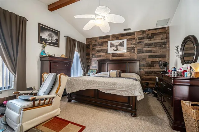 a bed room with furniture and a flat screen tv