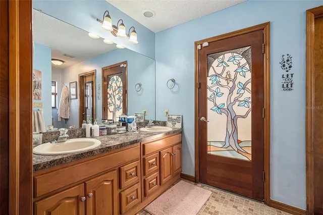 a bathroom with a double vanity sink and a mirror
