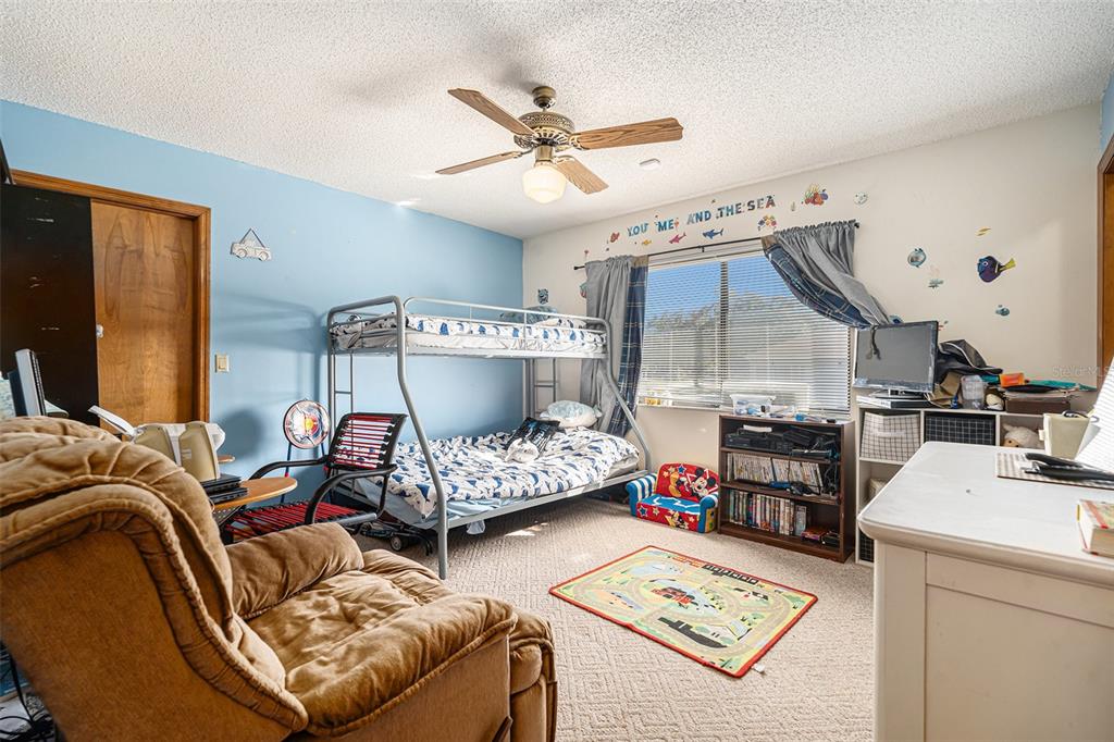 8212 Delaware Drive Weeki Wachee, FL 34607 - Photo 20 of 33 a bedroom with furniture and a bed