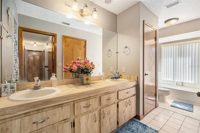 a bathroom with double sink and a mirror