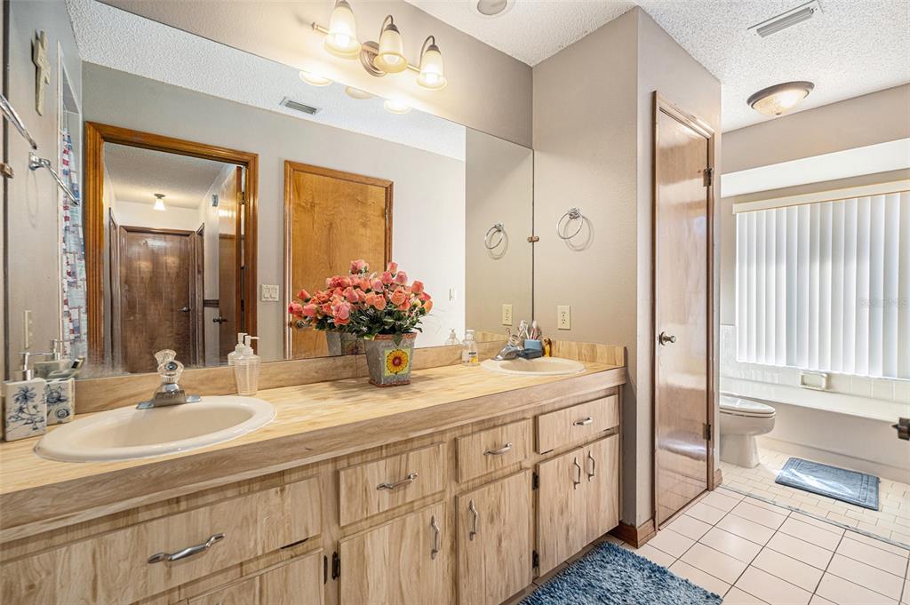 8212 Delaware Drive Weeki Wachee, FL 34607 - Photo 21 of 33 a bathroom with double sink and a mirror