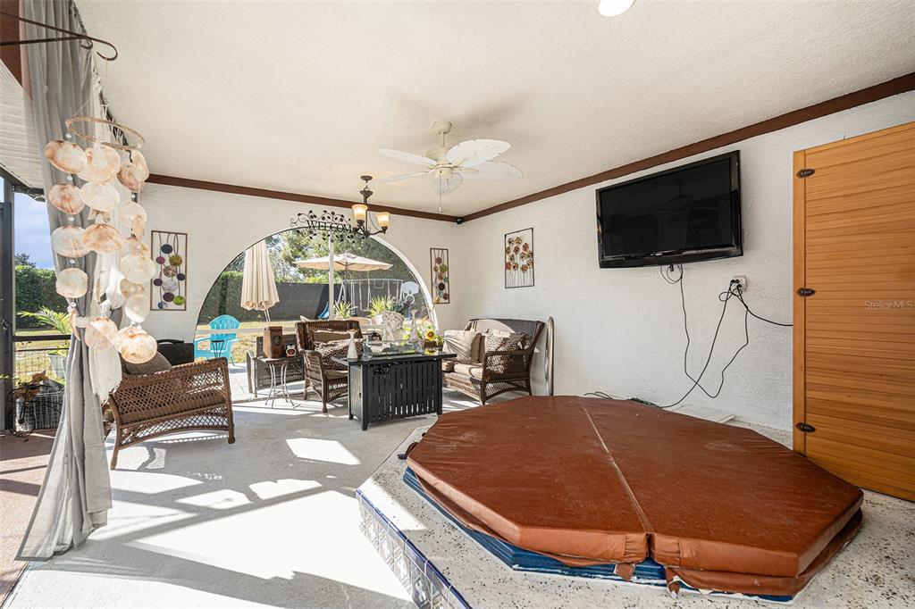 8212 Delaware Drive Weeki Wachee, FL 34607 - Photo 23 of 33 a room with furniture and a flat screen tv