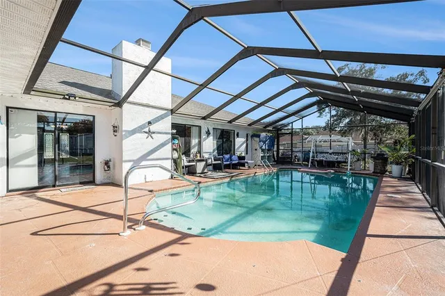a view of a swimming pool with a patio