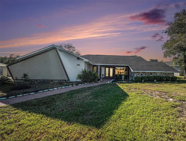 a front view of house with yard and green space