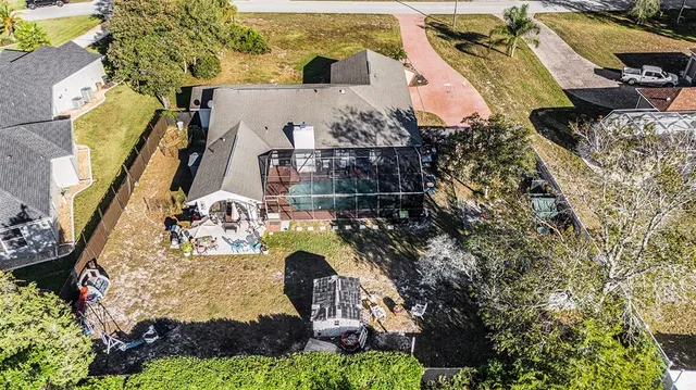 an aerial view of a house with swimming pool and garden