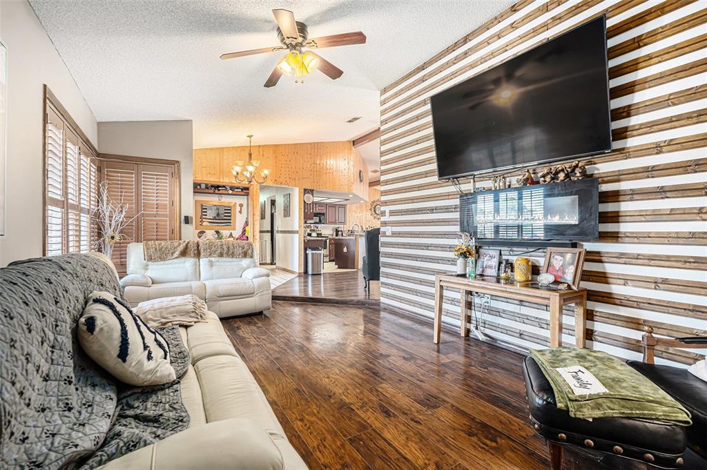 8212 Delaware Drive Weeki Wachee, FL 34607 - Photo 6 of 33 a living room with furniture and a flat screen tv