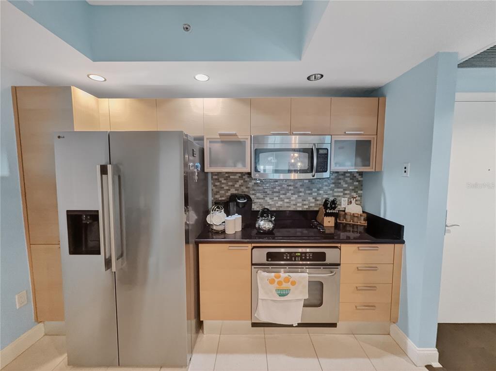 231 Riverside Drive, Unit 2081 Holly Hill, FL 32117 - Photo 11 of 38 a kitchen with stainless steel appliances granite countertop a stove and a refrigerator