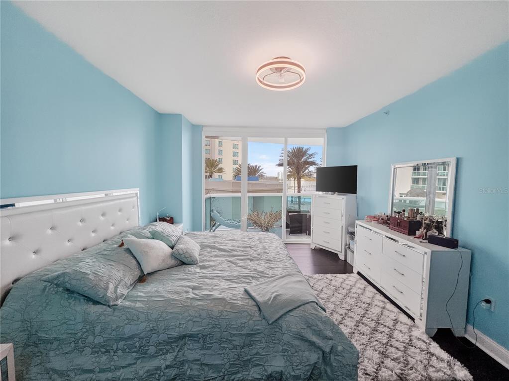 231 Riverside Drive, Unit 2081 Holly Hill, FL 32117 - Photo 13 of 38 a large bedroom with a bed and flat tv screen on the dresser