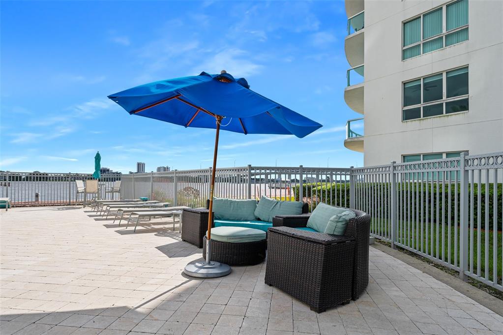 231 Riverside Drive, Unit 2081 Holly Hill, FL 32117 - Photo 35 of 38 a view of roof deck with couches under an umbrella