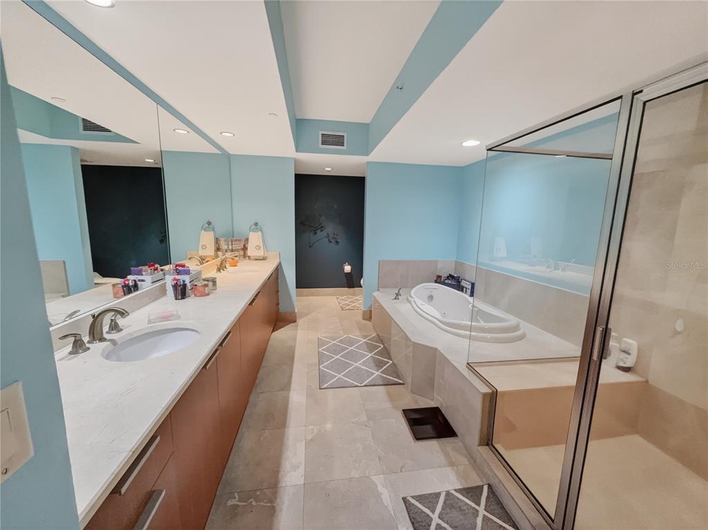 231 Riverside Drive, Unit 2081 Holly Hill, FL 32117 - Photo 8 of 38 a en suite bathroom with a tub sink and mirror