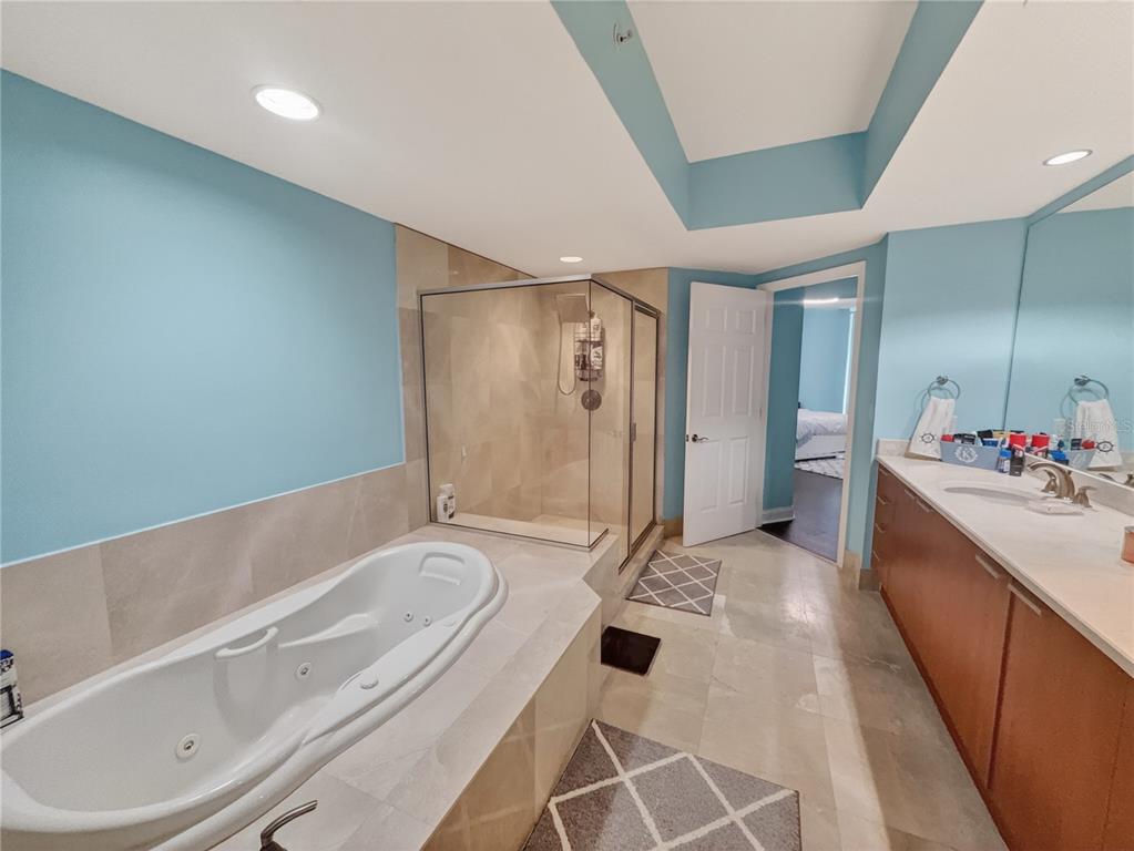 231 Riverside Drive, Unit 2081 Holly Hill, FL 32117 - Photo 9 of 38 a spacious bathroom with a tub sink shower and mirror