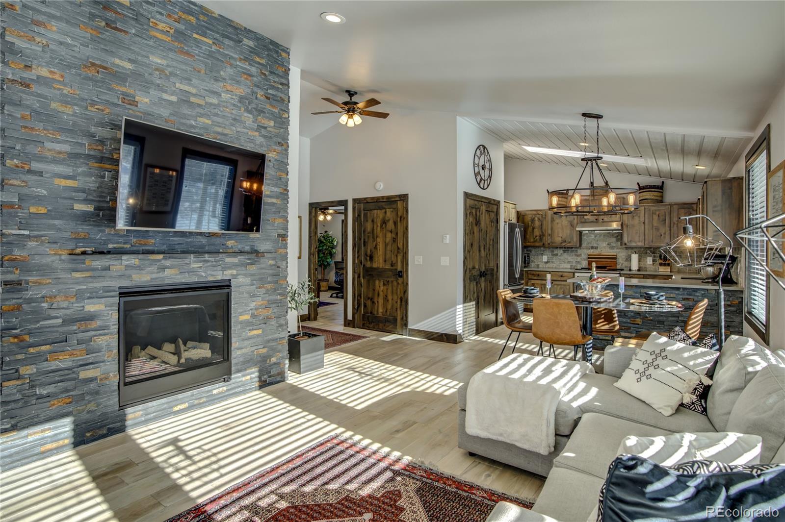 19273 Silver Ranch Road Conifer, CO 80433 - Photo 11 of 37 a living room with furniture and a fireplace