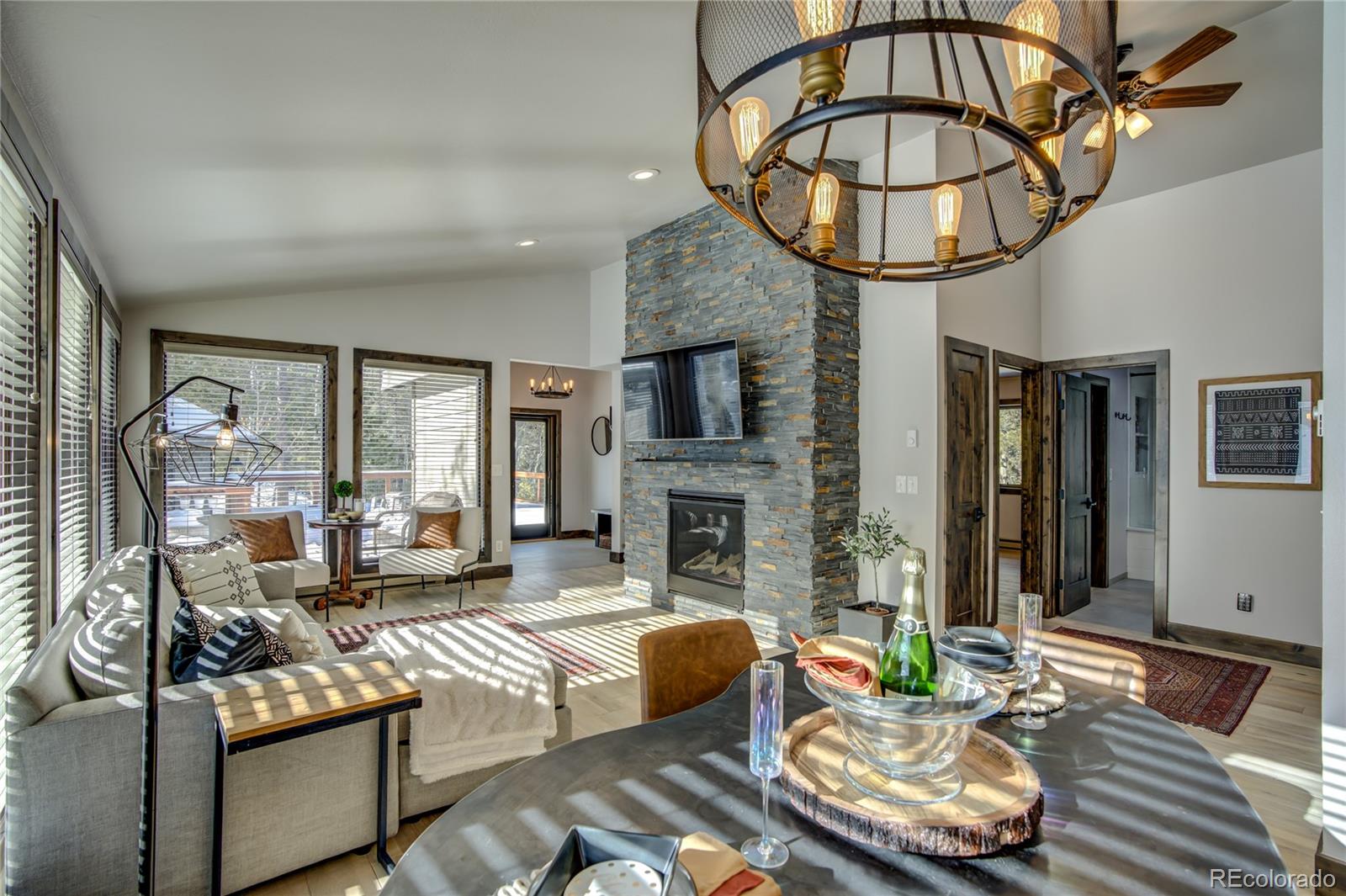 19273 Silver Ranch Road Conifer, CO 80433 - Photo 14 of 37 a living room with fireplace furniture and a wooden floor